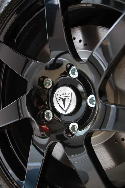 A closeup of a rim wheel used on a Tesla Roadster Sport.